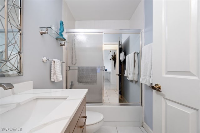 full bathroom with tile patterned floors, vanity, toilet, and enclosed tub / shower combo