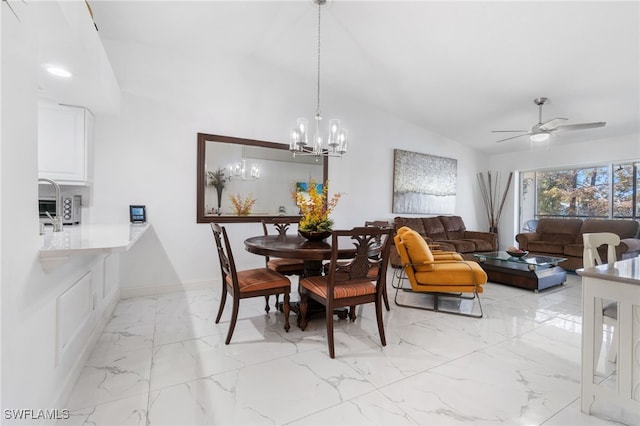 dining area with ceiling fan with notable chandelier and vaulted ceiling