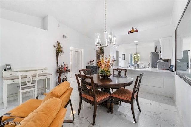 dining room with vaulted ceiling and a notable chandelier