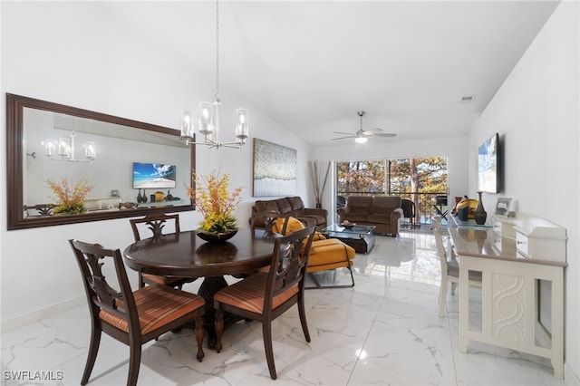 dining space with ceiling fan with notable chandelier and lofted ceiling