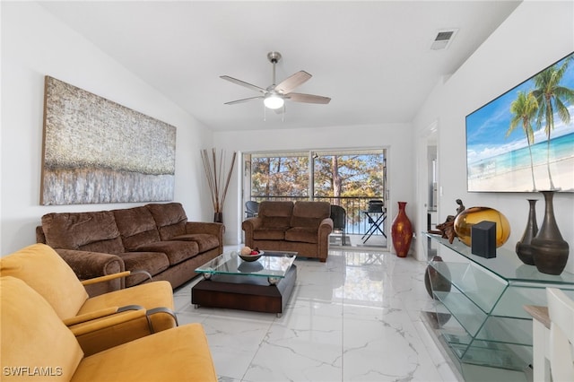 living room featuring ceiling fan and lofted ceiling