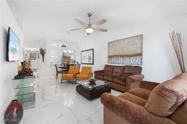 living room with ceiling fan with notable chandelier