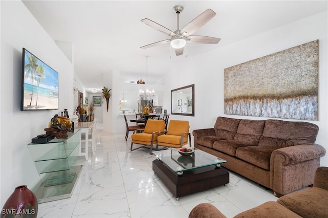 living room with ceiling fan with notable chandelier and vaulted ceiling