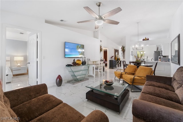 living room featuring ceiling fan with notable chandelier and vaulted ceiling