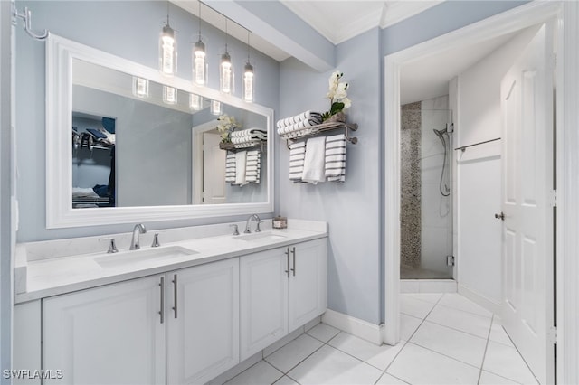 bathroom with tile patterned flooring, vanity, a shower with shower door, and ornamental molding