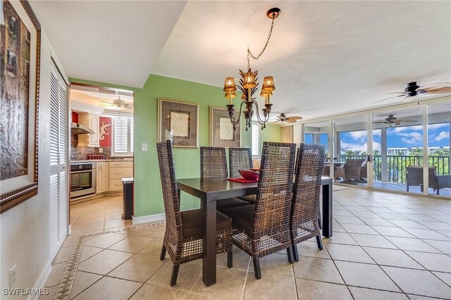 tiled dining space with ornamental molding and a chandelier