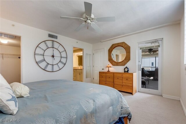 bedroom with light carpet, a closet, ensuite bath, and ceiling fan