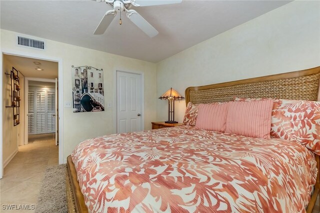 tiled bedroom with ceiling fan