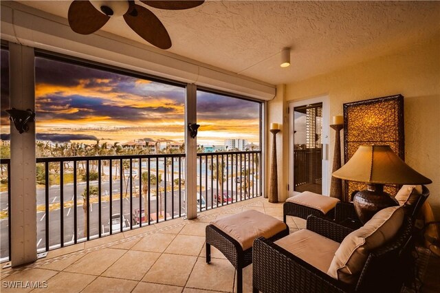 sunroom / solarium featuring ceiling fan