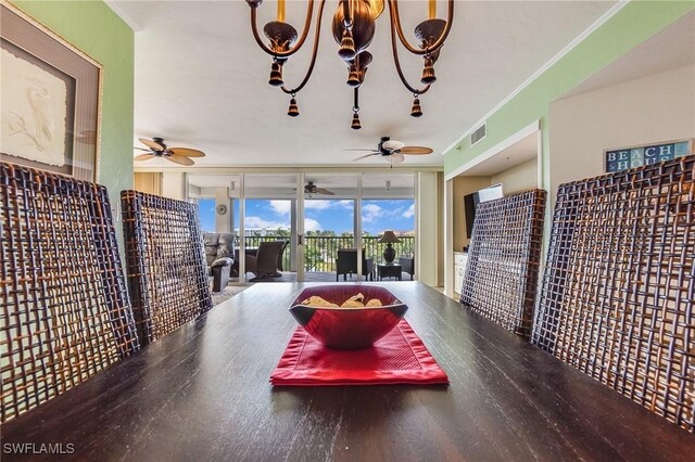 dining area with floor to ceiling windows, a chandelier, crown molding, and wood-type flooring