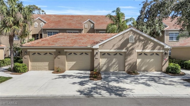 20111 Seagrove St Unit 604, Estero, FL 33928 - view of front facade with stucco siding, a tiled roof, and driveway