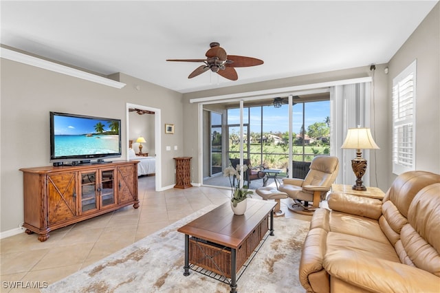 living room featuring ceiling fan, light tile patterned floors, and a healthy amount of sunlight