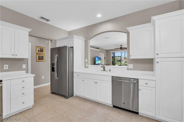 20111 Seagrove St Unit 604, Estero, FL 33928 - kitchen featuring appliances with stainless steel finishes, a sink, ceiling fan, arched walkways, and light countertops