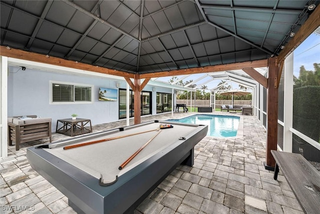 view of pool with a patio area and glass enclosure