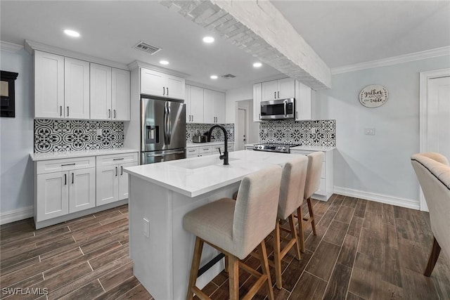 kitchen featuring sink, stainless steel appliances, and white cabinetry