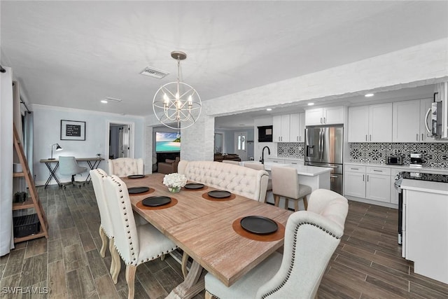 dining area with a notable chandelier and crown molding