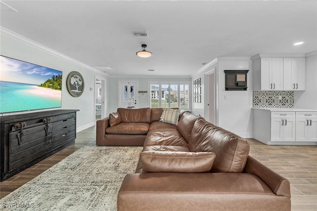 living room featuring ornamental molding and light hardwood / wood-style floors