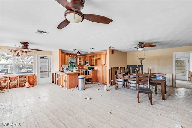 interior space with ceiling fan