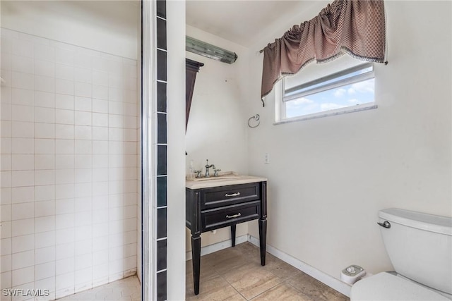 bathroom featuring vanity, toilet, and tile patterned flooring