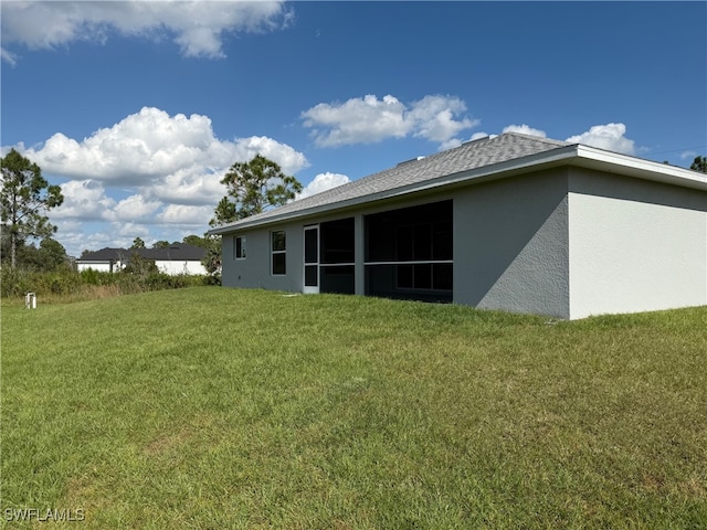 rear view of house featuring a lawn