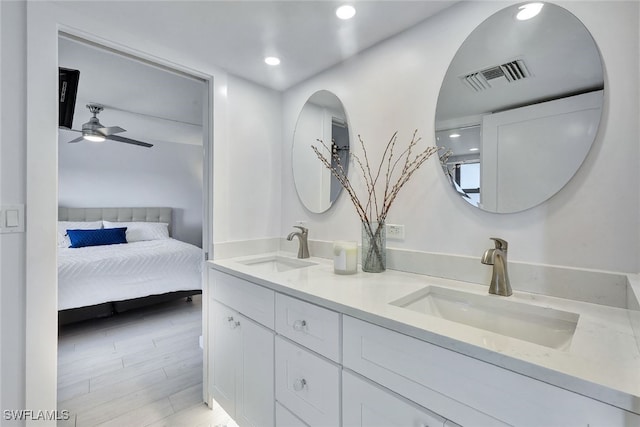 bathroom featuring ceiling fan, vanity, and wood-type flooring