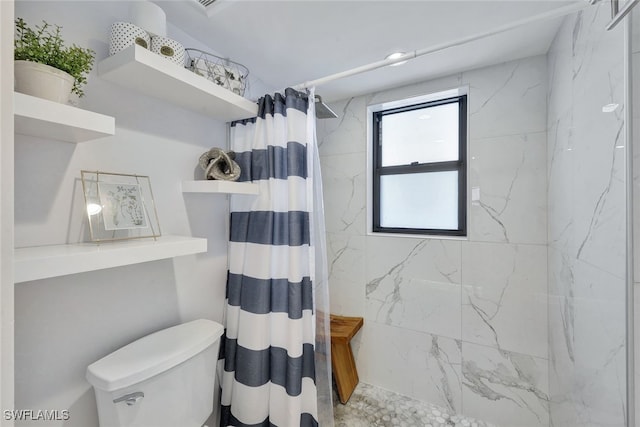 bathroom featuring a shower with curtain and toilet