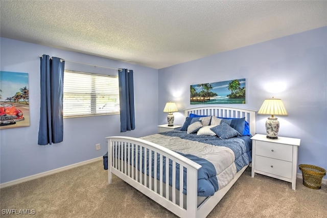 bedroom with a textured ceiling and carpet flooring