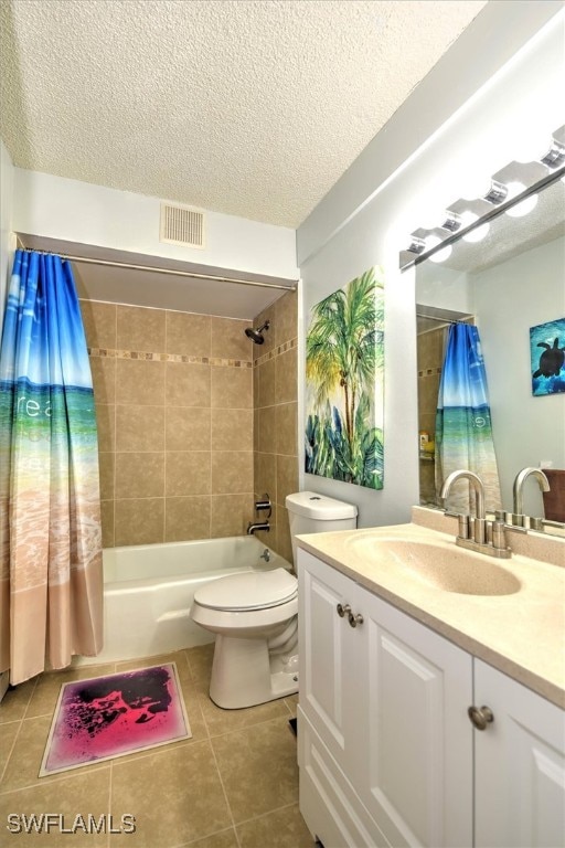 full bathroom featuring tile patterned floors, vanity, a textured ceiling, toilet, and shower / bath combo with shower curtain