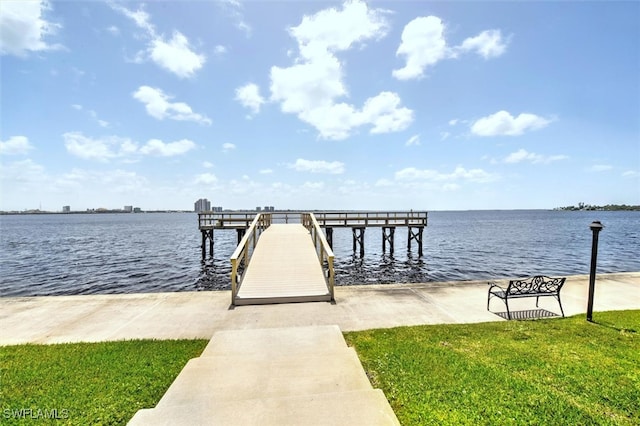 dock area featuring a yard and a water view