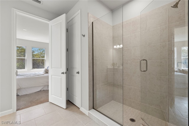 bathroom with tile patterned floors and a shower with shower door