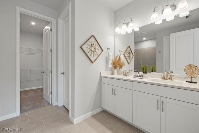 bathroom with vanity, tile patterned floors, and tiled shower