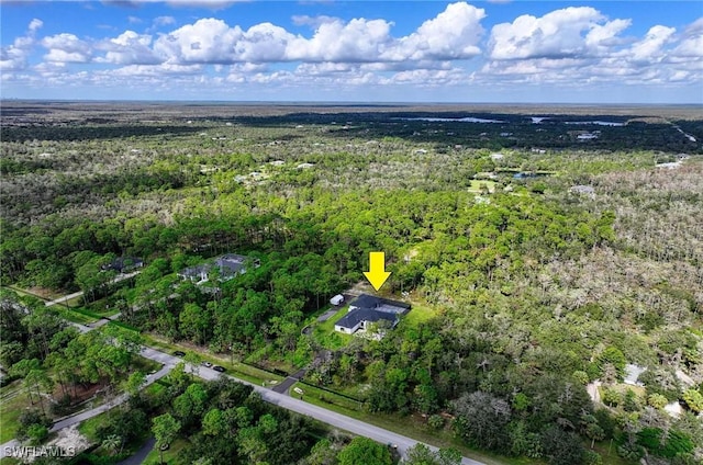 219 33rd Ave NW, Naples, FL 34120 - aerial view of property and surrounding area featuring a heavily wooded area