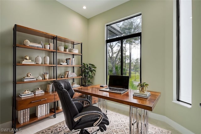 office area with plenty of natural light and light tile patterned flooring