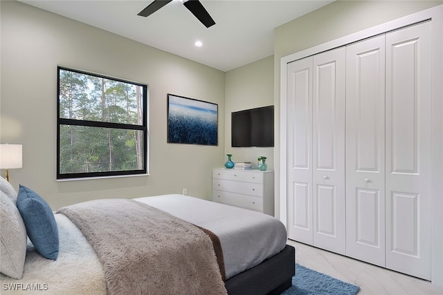 bedroom with ceiling fan and a closet