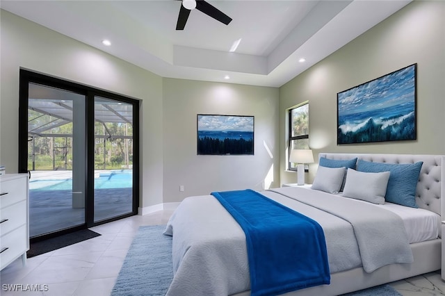 bedroom featuring access to outside, a raised ceiling, multiple windows, and ceiling fan