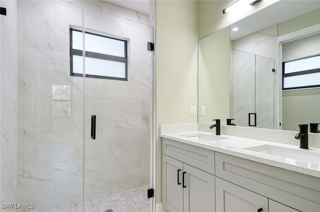 bathroom featuring vanity, walk in shower, and a healthy amount of sunlight