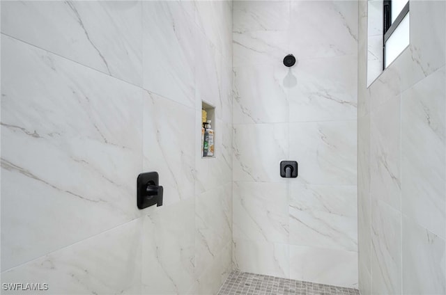 bathroom with tiled shower