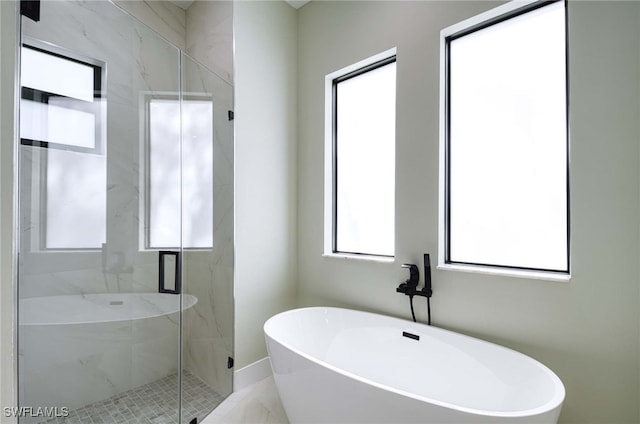 bathroom featuring separate shower and tub and a wealth of natural light