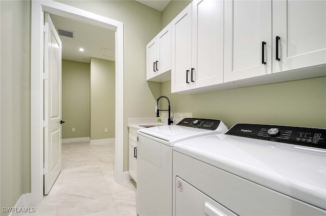 clothes washing area with cabinets, independent washer and dryer, and sink