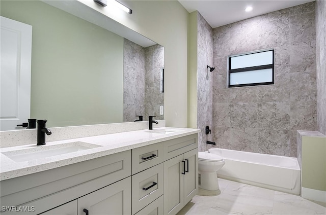 full bathroom featuring vanity, tiled shower / bath combo, and toilet