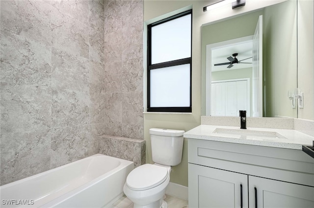 full bathroom with vanity, ceiling fan, toilet, tile walls, and tub / shower combination