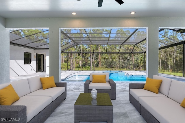 interior space with ceiling fan, plenty of natural light, and a swimming pool