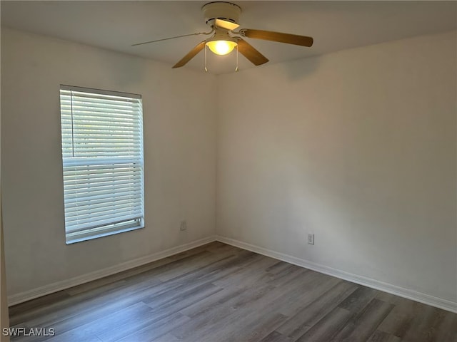 unfurnished room with hardwood / wood-style flooring and ceiling fan