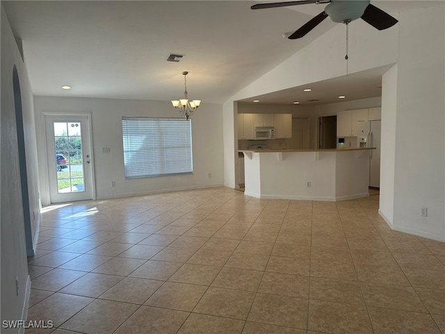 unfurnished living room featuring ceiling fan with notable chandelier, lofted ceiling, and light tile patterned floors