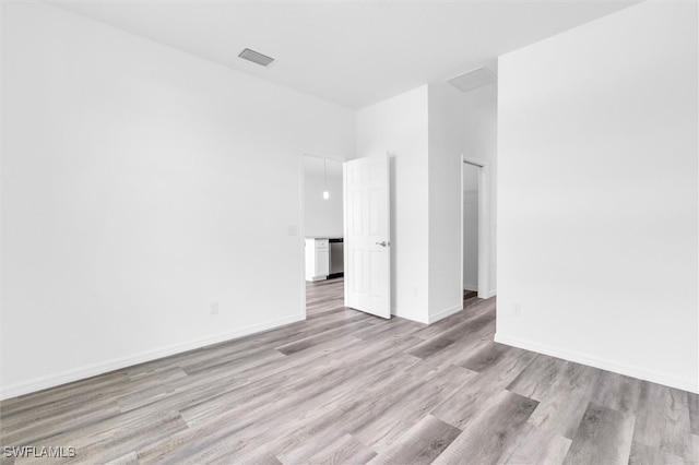 spare room with light hardwood / wood-style floors