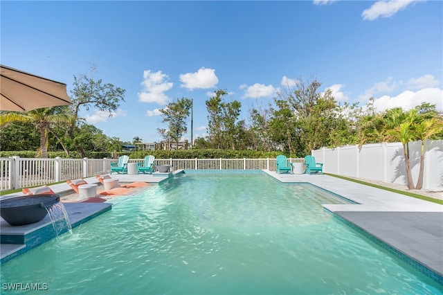 view of swimming pool featuring pool water feature and a patio area