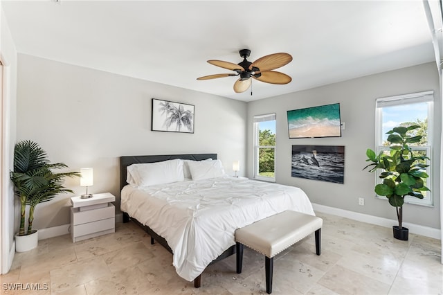 bedroom featuring ceiling fan and multiple windows