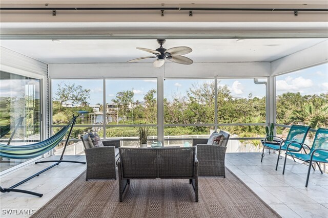 sunroom featuring ceiling fan