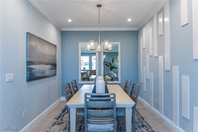 dining space with a chandelier, hardwood / wood-style flooring, and crown molding