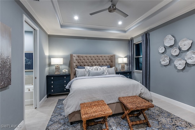 bedroom with ensuite bath, a raised ceiling, ceiling fan, and crown molding